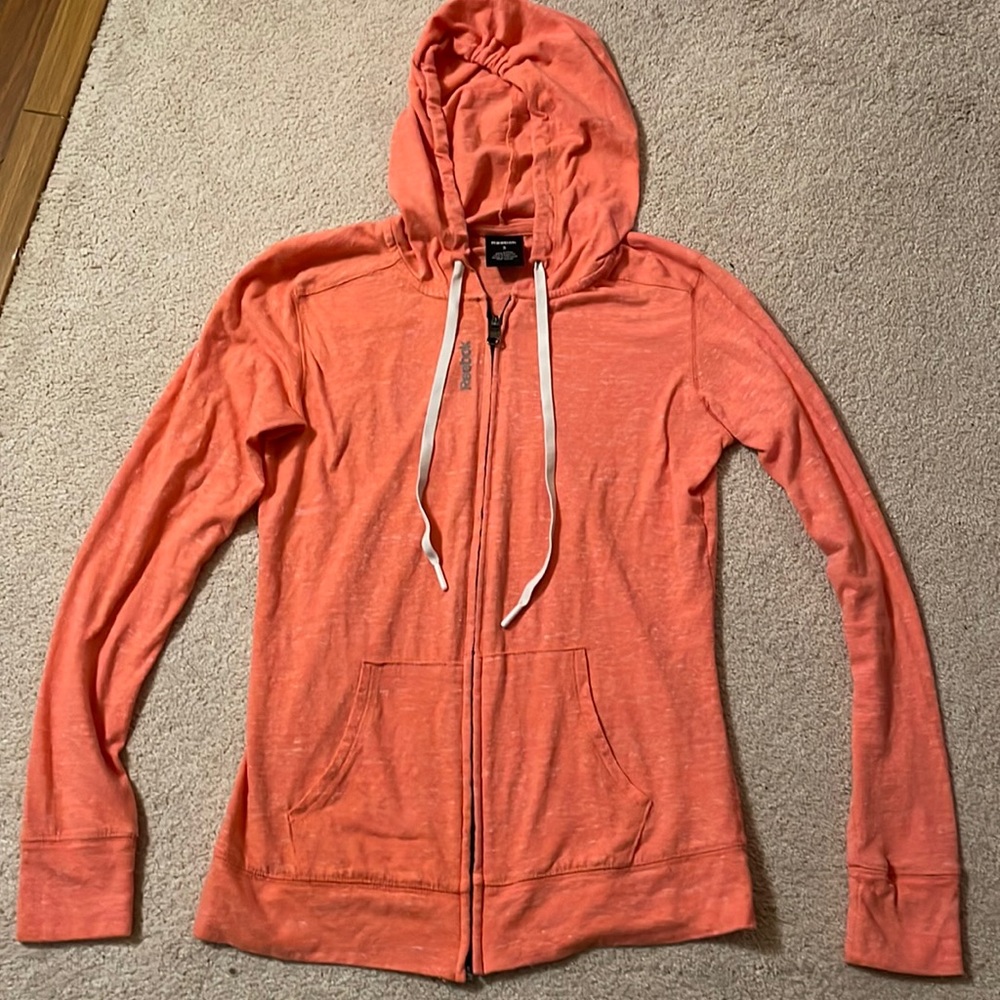 Reebok light-weight orange with white specked jacket, size S.